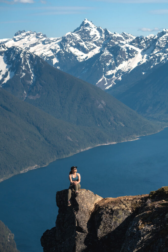 Female Hiker sitting on a rock on top of Goat Ridge in Chilliwack