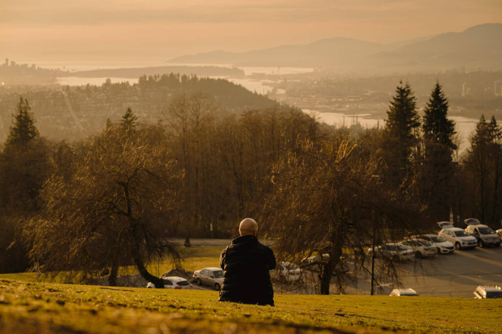 Man watching the sunset from Burnaby Mountain