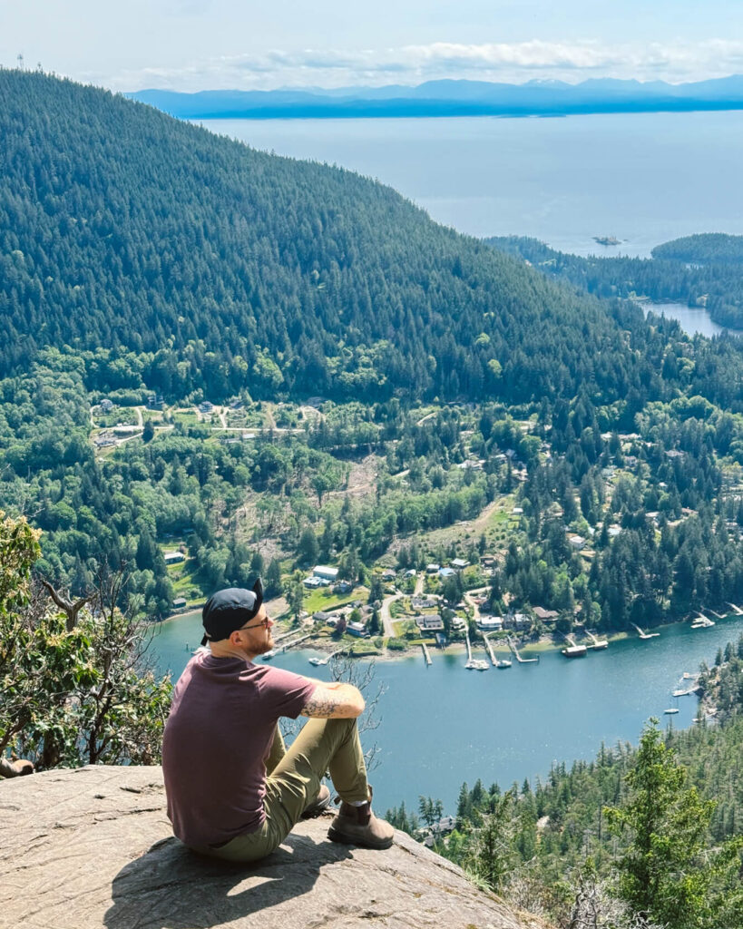 Hiker looking at the view of Pender Harbour from the top of Mount Daniel